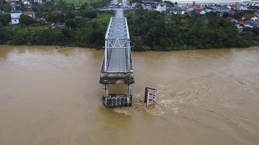 Bridge collapses as more rain falls in Vietnam and storm deaths rise to 21