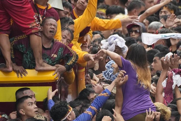 Filipino Catholics pray for Mideast peace in massive procession venerating a black statue of Jesus