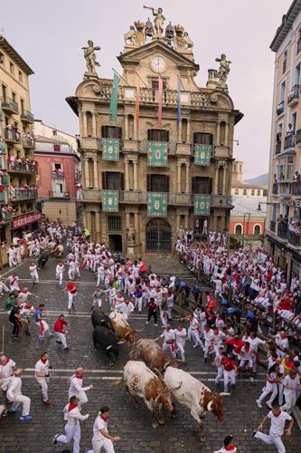 Daredevils run with charging bulls at Pamplona's famous San Fermín festival
