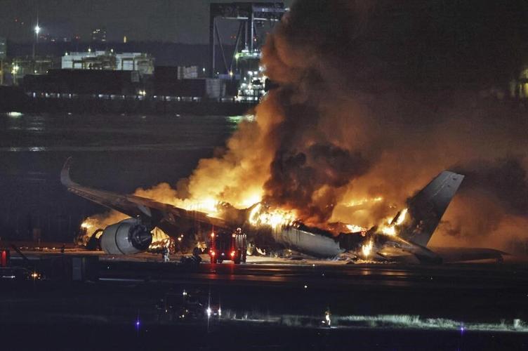 Plane catches fire on runway at Japan's Haneda airport after collision, passengers reportedly safe