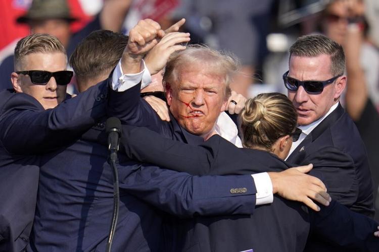 Trump is injured but 'fine' after apparent assassination attempt leaves rally-goer and gunman dead