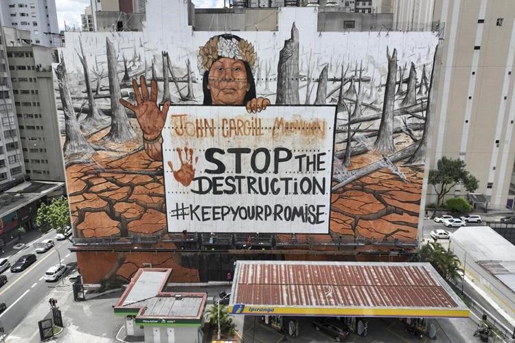 A Brazilian artist uses ash and mud for a massive Sao Paulo mural lamenting climate disasters