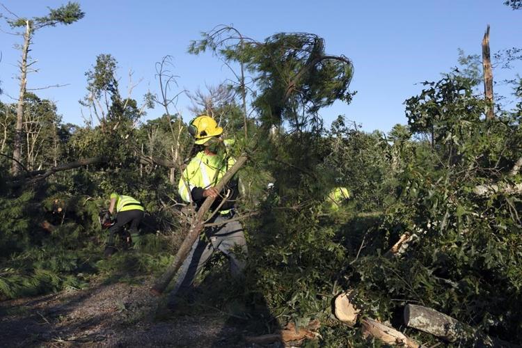 Rare New England tornado lifts car from a highway as strong storms damage homes and flood roads