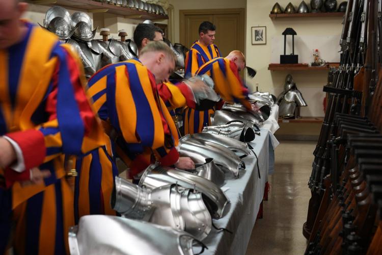 A look at Swiss Guards preparing for a swearing-in ceremony attended by the Pope, in photos