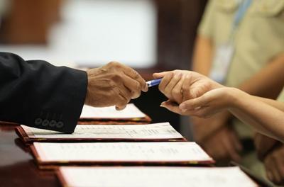 Cambodian lawmakers approve changes to election law that disqualify candidates who don't vote