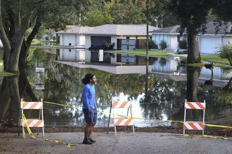Residents slog through flooded streets, clear debris after Hurricane Milton tore through Florida