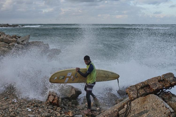 Photos show surfers riding waves along Gaza City’s damaged coastline