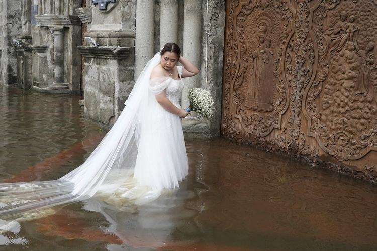 Photos show a Filipino couple walking down a flooded aisle on their wedding day