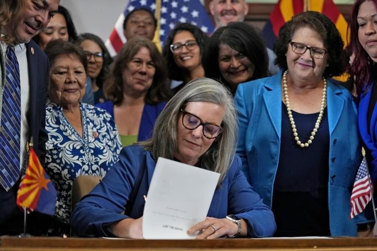 Arizona governor's signing of abortion law repeal follows political fight by women lawmakers