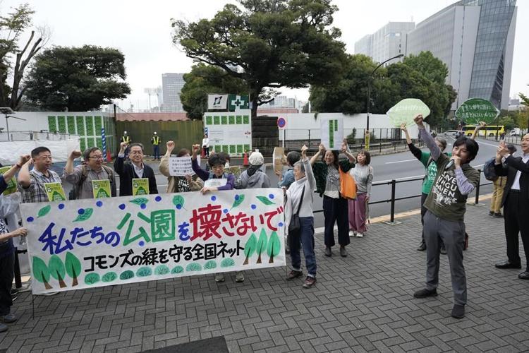 Developers begin cutting trees in a Tokyo park that environmentalists want to protect