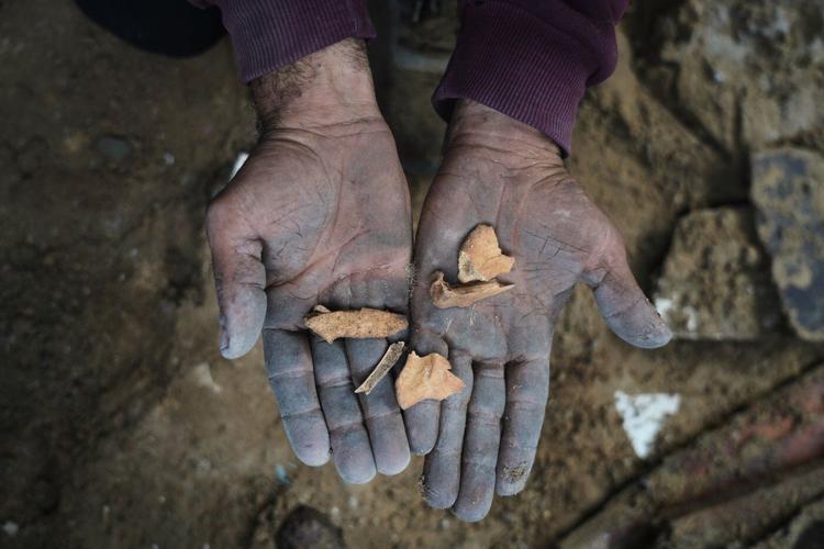 A father in Gaza searches for his family's bones in the rubble of their home