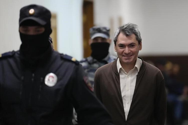 Jailed leader of a prominent election watchdog is on trial in Russia