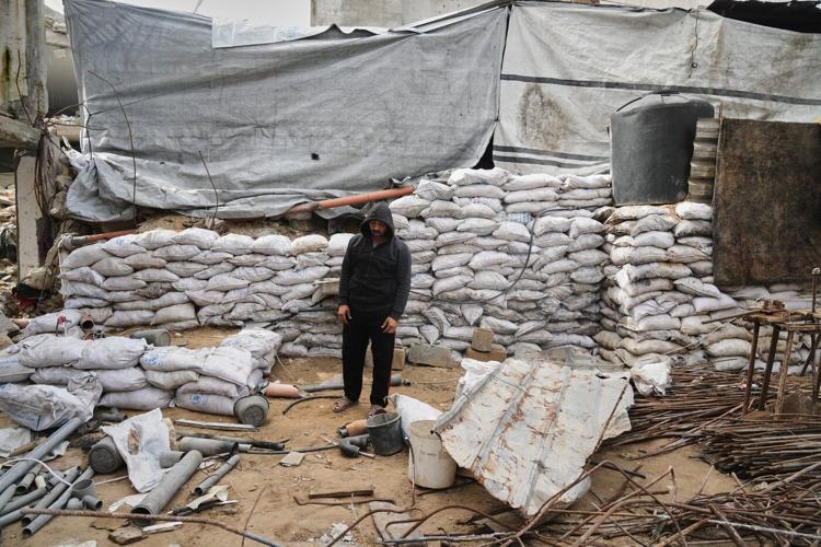A father in Gaza searches for his family's bones in the rubble of their home