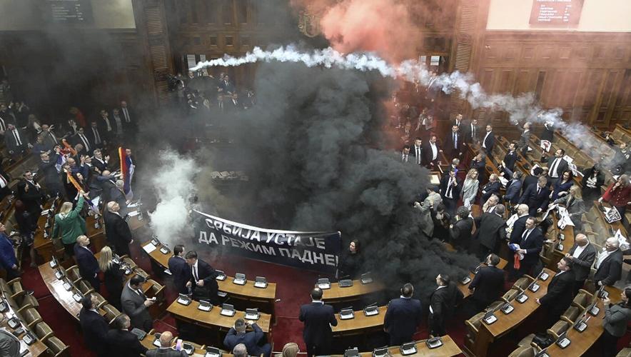 At least 3 Serbian lawmakers injured as smoke bombs and flares thrown in parliament