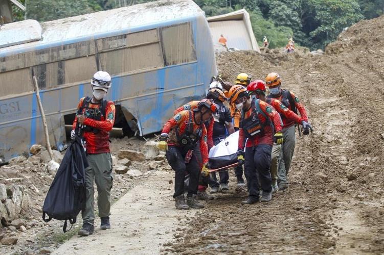 54 people are confirmed dead in a landslide that buried a gold-mining village in south Philippines