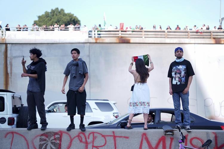 Marchers protesting planned deportations block major freeway in Los Angeles
