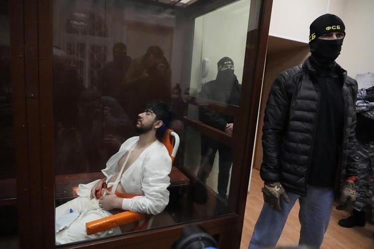 4 men charged in Moscow attack, showing signs of beatings at hearing as court says 2 accept guilt
