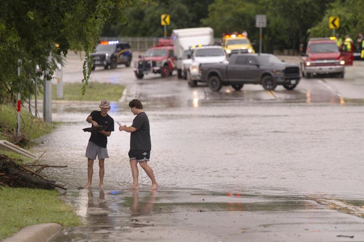 Texas flooding surges from huge rainstorms as rescuers pull people from rising waters