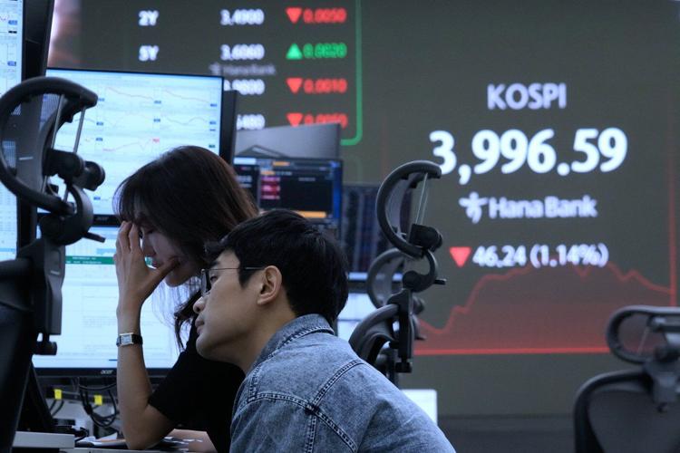 Asian shares are mixed as region watches for outcome from Trump's visits