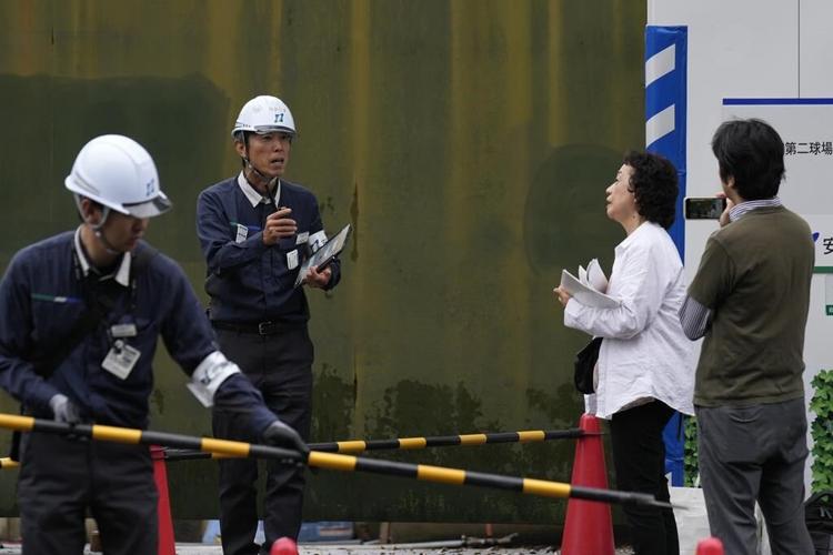 Developers begin cutting trees in a Tokyo park that environmentalists want to protect