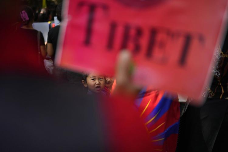 Tibetans scuffle with police outside the Chinese Embassy in India as they mark uprising anniversary