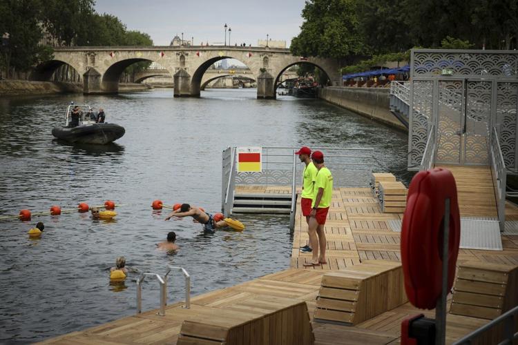 Joyful Parisians take a historic plunge into the Seine after 100 years