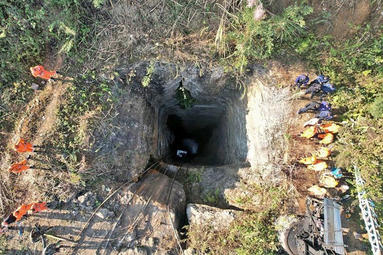 Indian army divers retrieve the body of one of at least 9 miners trapped in a flooded coal mine