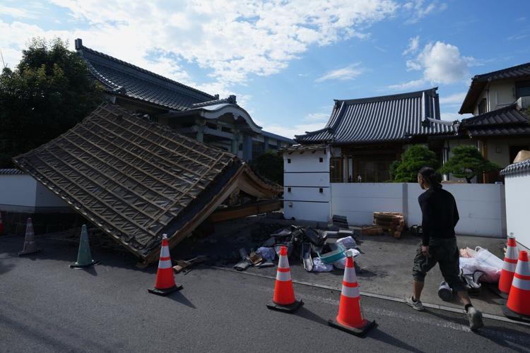 Rescuers search for survivors after a 7.1 quake kills 18 in southwestern Japan
