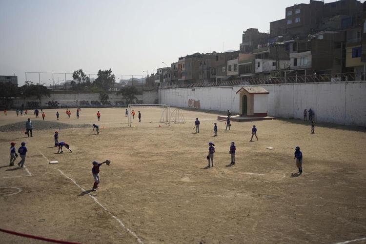 Baseball becomes a shelter for Venezuelan children in soccer-mad Peru
