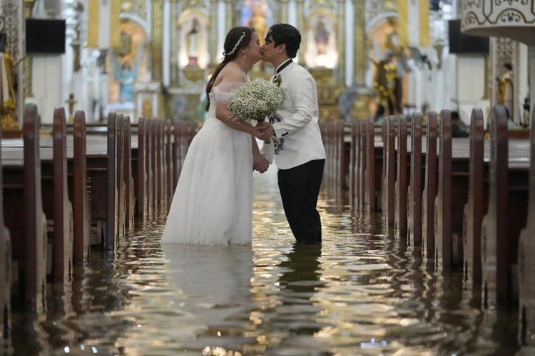 Photos show a Filipino couple walking down a flooded aisle on their wedding day