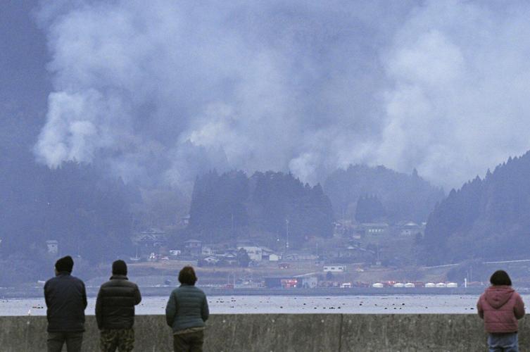 Japan fights a forest fire that has damaged dozens of homes and caused hundreds to evacuate