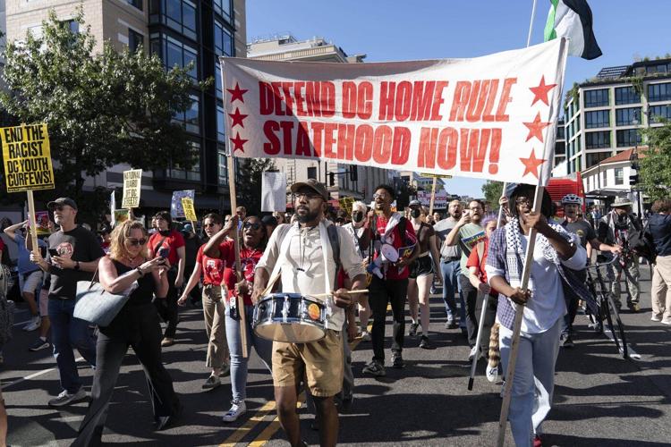 Photos of week three of Washington's federal takeover, as troops on patrol start carrying guns