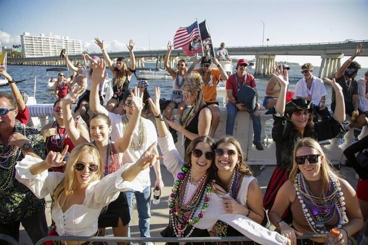 Revelers in festive dress fill downtown Tampa, Florida, for the annual Gasparilla Pirate Fest