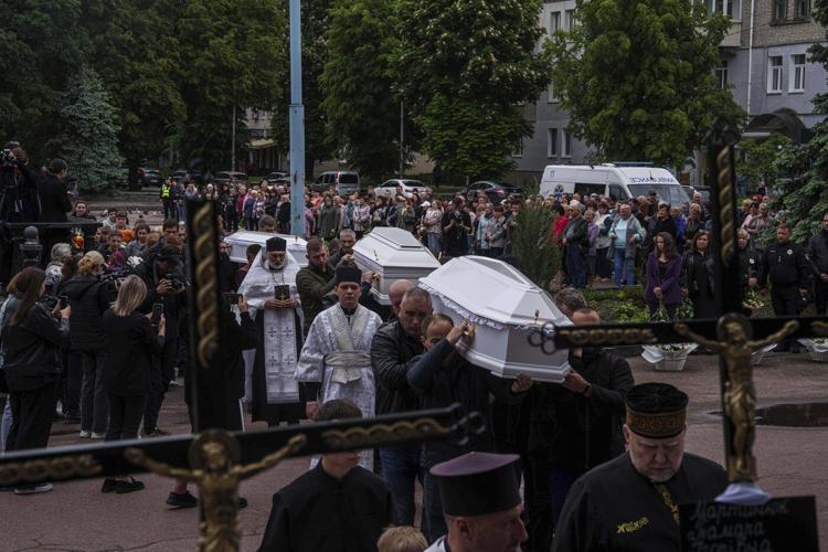 AP PHOTOS: 3 Ukrainian siblings buried after Russian missile strike