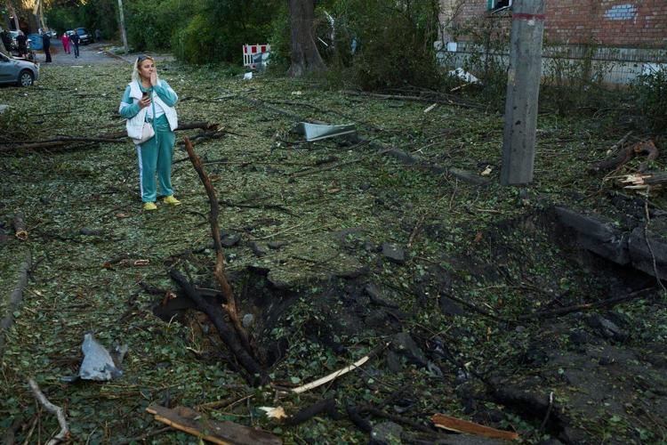 Photos show Kyiv residents clutching pets, collecting bodies after Russian missile and drone attack