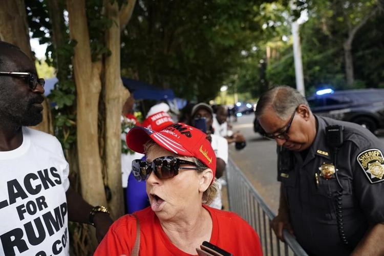 Scores of Trump supporters show support outside Georgia jail ahead of his expected surrender