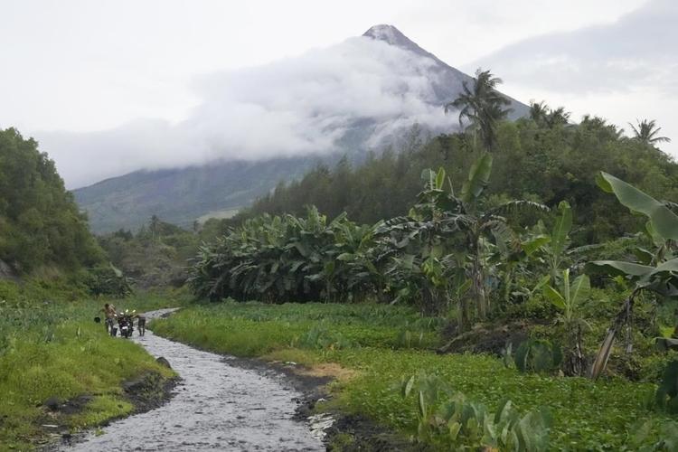 Rains unleashed by typhoon worry thousands of people fleeing restive Philippine volcano