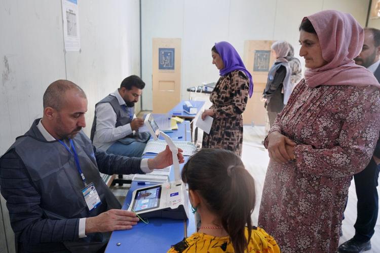Photos show Iraqi security forces and displaced people voting early in parliamentary election