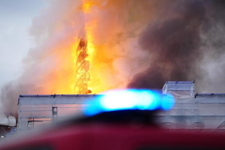 Fire rages through the 17th-century old Stock Exchange in Copenhagen and its spire has collapsed