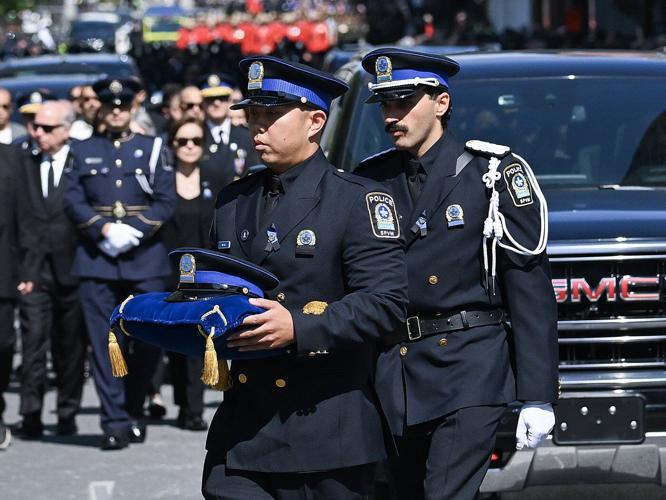 Police officers march in Montreal ahead of funeral for officer killed in shooting