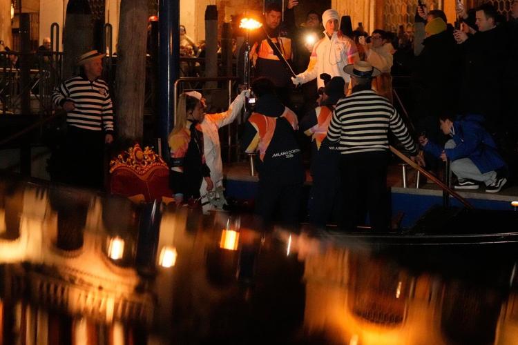 Olympic flame makes historic passage down Venice's Grand Canal