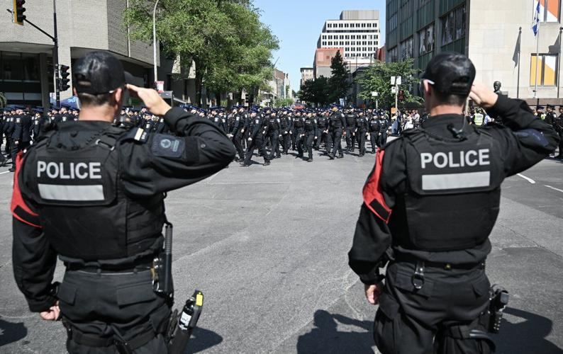 Police officers march in Montreal ahead of funeral for officer killed in shooting