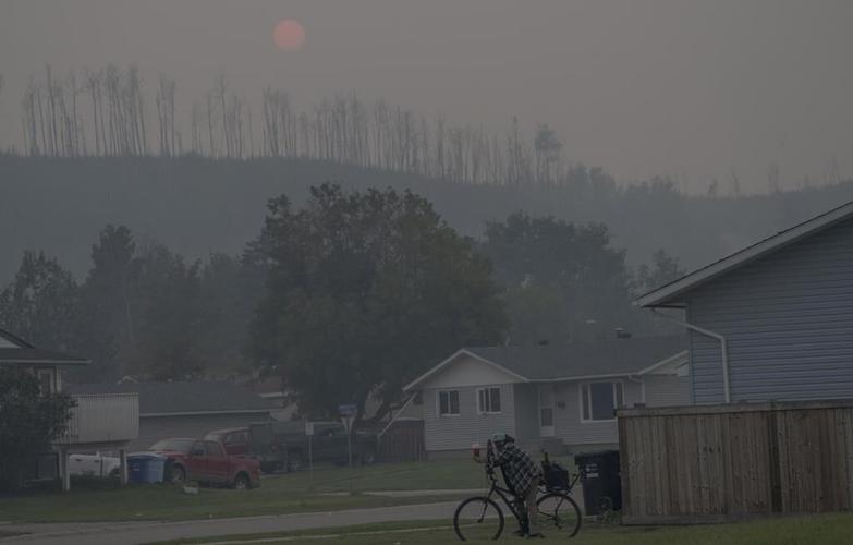 Canada says it can fight climate change and be major oil nation. Massive fires may force a reckoning
