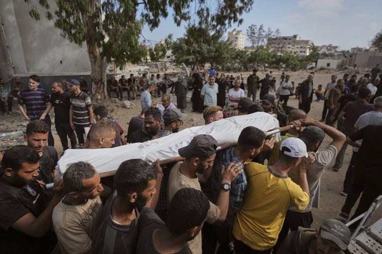 Photos show people mourning after airstrikes and shooting in Gaza overnight