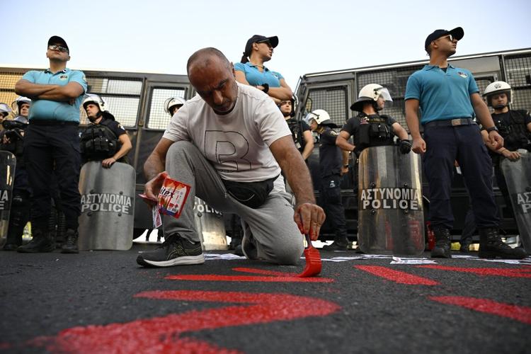 Riot police block protesters from approaching Israeli cruise ship in Greece