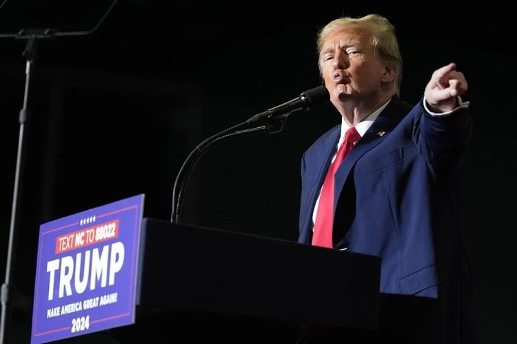 Trump escalates his immigration rhetoric with baseless claim about Biden trying to overthrow the US