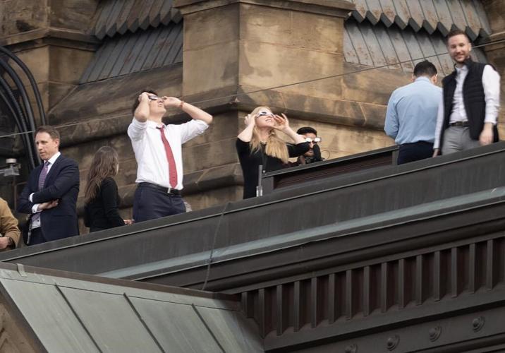 MPs clad in eclipse glasses stare at 'surreal' celestial event on Parliament Hill