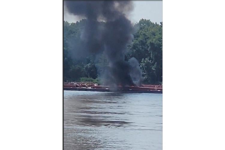 Two die when helicopter strikes powerlines and crashes into a barge on the Mississippi River