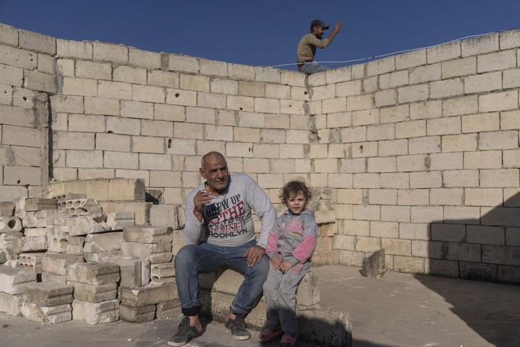 AP PHOTOS: In northern Syria, displaced owners return to houses with no roofs