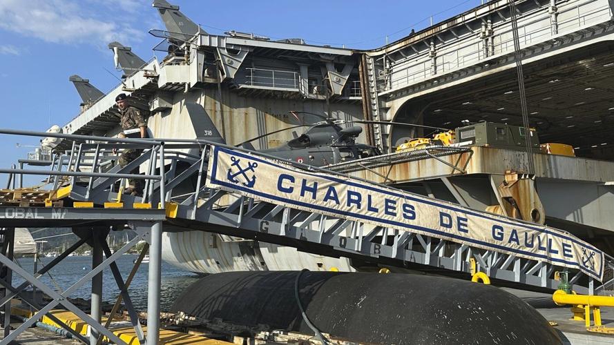 French aircraft carrier stages combat drills with Filipinos in disputed sea and visits Philippines